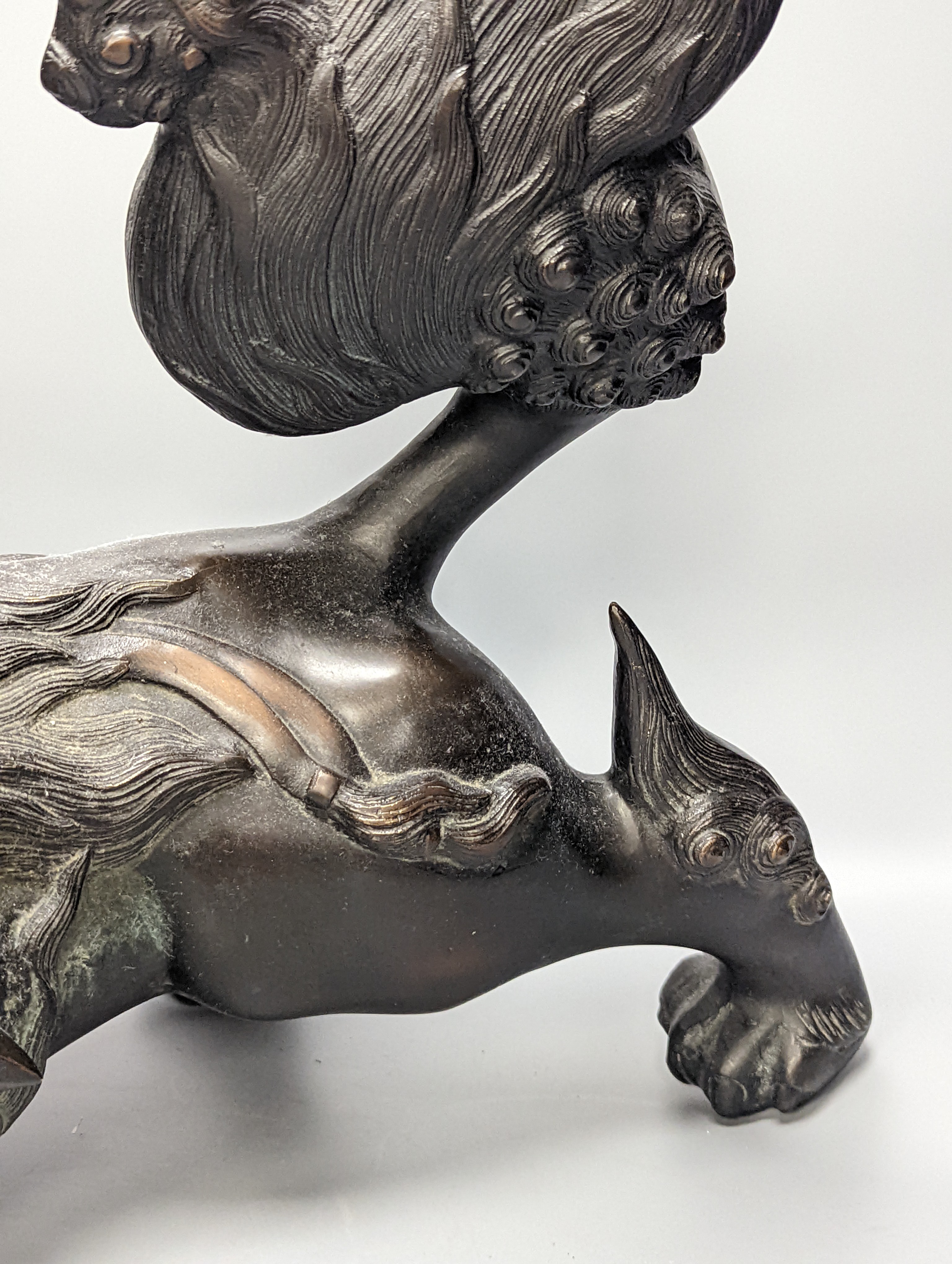 A large Chinese or Japanese bronze figure of a lion-dog or kara shi-shi, 45 cm long